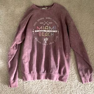 A large pink crew neck from a small boutique shop in Florida